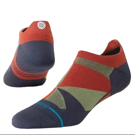A pair of Stance Ultraboost no-show socks in a geometric color-blocked pattern of navy, rust red, sage green, and light blue, with a black circular badge in the top right reading 'ULTORA LIGHT CUSHION'.