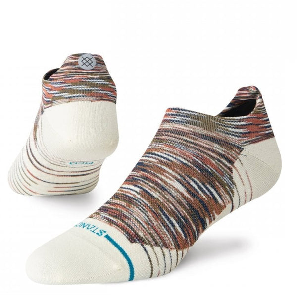 A pair of low-cut ankle socks by Stance, featuring a multicolor wavy stripe pattern in brown, orange, blue, and white, with a solid cream-colored toe and heel.